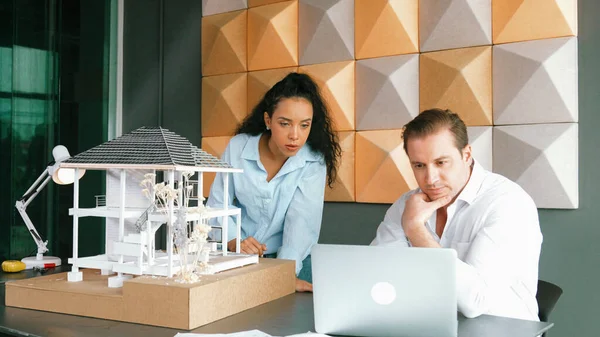 Two skilled professional architect engineer team discuss about house model structure. Project manager working together to create house design. Brainstorming. Business design concept. Manipulator..