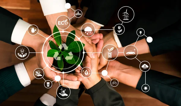 Business partnership holding plant together with recycle icon symbolize ESG sustainable environment nurturing and ecosystem protection with eco technology and waste recycling. Panorama Reliance