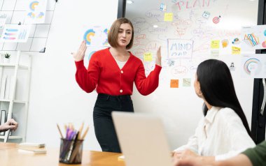 Profesyonel çekici kadın lider, modern iş toplantı odasında beyin fırtınası zihin haritalama istatistikleri ve renkli yapışkan notlar kullanarak yaratıcı pazarlama planını sunuyor. Tertemiz..