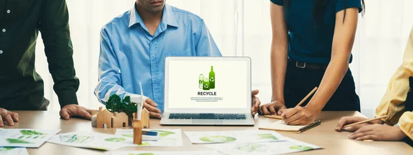 Recycle packaging displayed on laptop at a green business meeting while business team presenting green design. ESG environment social governance and Eco conservative concept. Closeup. Delineation.