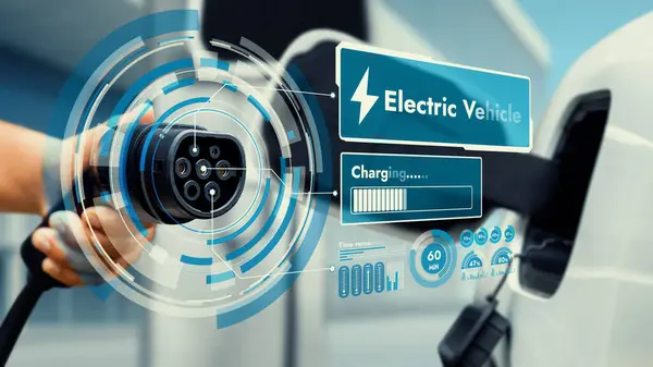 stock image Focus hand pointing EV charger in front of camera display smart battery status hologram in blurry background. Electric car charger using clean energy reducing CO2 emission.Peruse