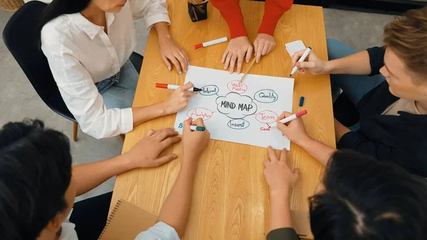 Top view of professional business people hand brainstorming, working together, discussing about marketing idea by using mind map and colorful marker at meeting table. Focus on hand. Immaculate.