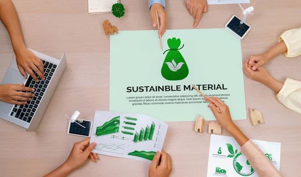 Sustainable material illustration placed on a meeting table during a green business meeting discussion. ESG environment social governance and Eco conservative concept. Top view. Delineation.