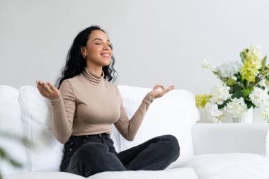 Young African American woman practice crucial mindful meditation at home living room for improving mental health strength and peaceful beautiful living clipart