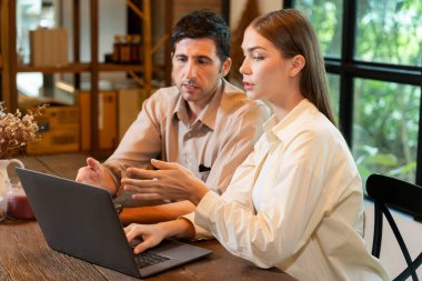 Baharda Cafe Garden 'da dizüstü bilgisayarda çalışan genç bir çift kahve dükkanındaki dinginlik ortamının tadını çıkarıyor. Uzaktan çalışan ya da blog yazan dijital göçebe ya da üniversite öğrencisi. Yararlı