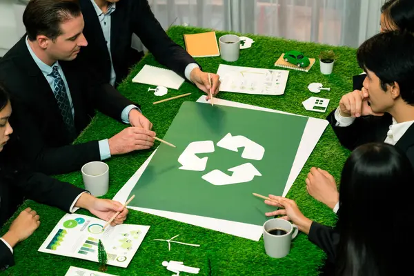 Recycle icon on meeting table in office with business people planning eco business investment on waste management as recycle reduce reuse concept for clean ecosystem. Quaint
