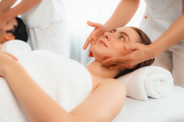 Kafkasyalı çift stres önleyici kafa masajının keyfini çıkarıyor ve lüks otellerde ya da otel spa salonlarında gündüz kaplıcalarında yüz güzelliği eğlencelerini şımartıyor. Sessiz.