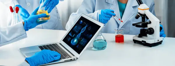 Laboratory research team advance healthcare with scientific expertise, laboratory equipment, and innovative medical biotechnology software, researching new medicines and developing cure.Panorama Rigid
