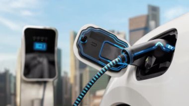 Elektrikli araba şarj istasyonuna bağlanır ve şehrin arka planında gelişmiş EV şarj cihazıyla şarj edilir. Gelecekteki yenilikçi çevre dostu enerji sürdürülebilirliği CO2 emisyonunu azaltmak için. İnceleyin