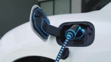 Fütürist EV şarj cihazıyla elektrikli araba şarj istasyonundan şarj oluyor. EV arabaların son teknoloji gelişimi ve sürdürülebilir enerji için akıllı ev yenilenebilir enerji altyapısı. İnceleyin