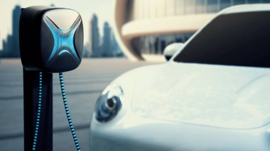 Elektrikli araba şarj istasyonuna bağlandı. Şehrin arka planına sahip EV şarj kablosu ile pili şarj etmek için. Geleceğin yenilikçi her arabası ve enerji sürdürülebilirliği. İnceleyin