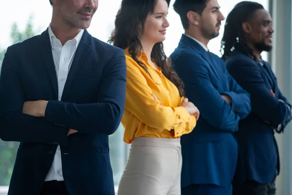 A diverse group of candidates stands together with arms crossed, confident and determined. A Successful businesswoman and her smart team smiling. Cropped side view. Office uniform. Intellectual.
