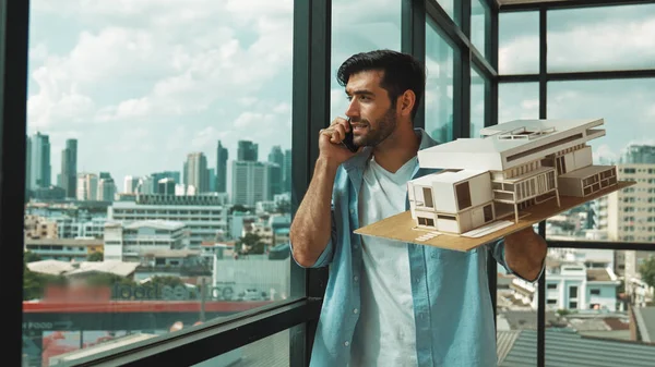 Smart Caucasian Engineer Standing Holding House Model While Phone Calling — Stock Photo, Image