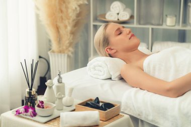 Kafkasyalı kadın müşteri stres önleyici spa masajının keyfini çıkarıyor ve lüks otel ya da oteldeki gündüz açık ortam güzellik salonunda güzellik teniyle eğleniyor. Sessiz.