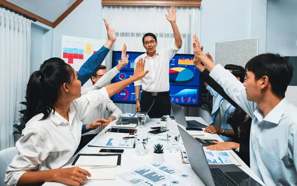 stock image Analyst team leader celebrate with his colleague after successful data analysis meeting using FIntech software power with business intelligence or BI dashboard. Prudent