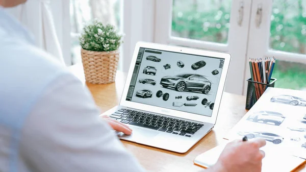 Car design engineer analyze car prototype for automobile business at home office. Automotive engineering designer carefully analyze, finding flaws and improvement for car design with laptop Synchronos