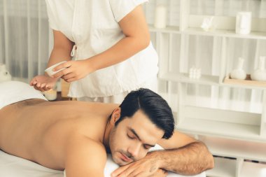 Kafkas erkek müşteri stres önleyici spa masajının keyfini çıkarıyor ve lüks otel veya oteldeki gündüz açık hava ortamında güzellik derisi eğlencesi ile şımartıyor. Sessiz.