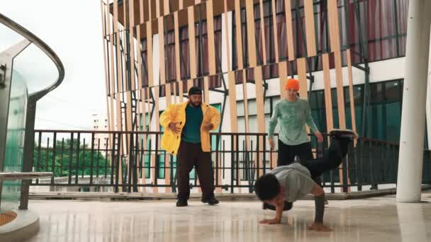 回廊モールのヒップホップ音楽に足跡を移動するヒップスターのグループ 熟練したブレイクダンサーは 多文化の友人やダンサーグループに囲まれてBボーイダンスを行います アウトドアスポーツ 2024 ヒップホップ — ストック動画