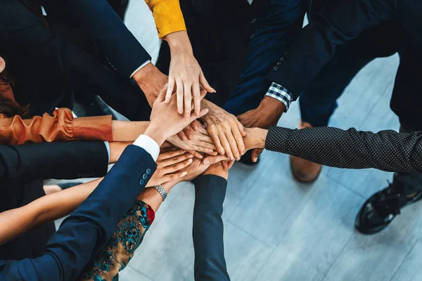 A group of diversity people putting their hands together. Showing unity teamwork and friendship. Close up top view of young business man and business woman joining as a team. Intellectual.