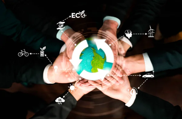 Business partnership holding Earth globe together with eco sustainability icon symbolize ESG sustainable environment and ecosystem protection with eco technology and carbon reduction. Reliance