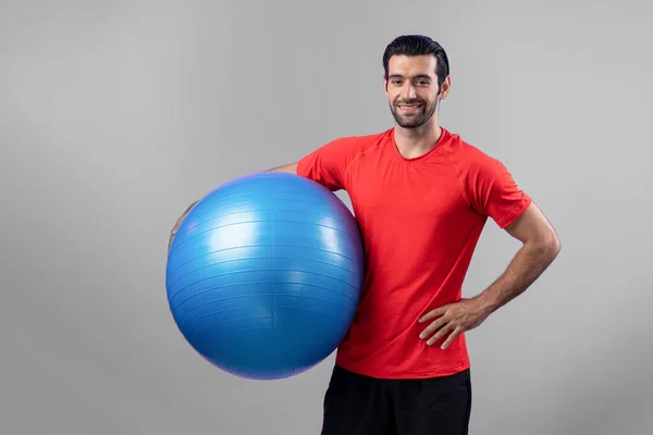 Full body length gaiety shot athletic and sporty young man with fitness exercising ball in standing posture on isolated background. Healthy active and body care lifestyle.