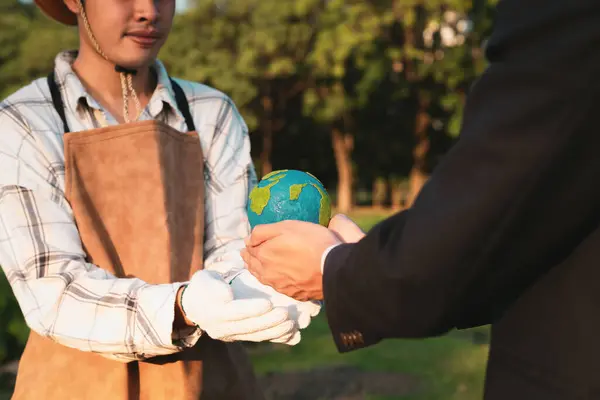 stock image Eco-business company empower farmer with eco-friendly farming practice and clean agricultural technology. Cultivate sustainable future and holding Earth globe symbolize commitment to environment.Gyre