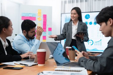 Genç Asyalı iş kadını modern toplantıda TV ekranında veri analizi paneli sunuyor. Bir grup iş adamıyla konferans odasında iş sunumu. Uyum