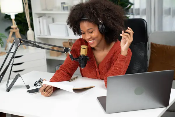 Host channel of beautiful African woman talking in online broadcast teaching marketing influencer, with listeners in broadcast or online. Concept of anywhere at work place. Tastemaker.