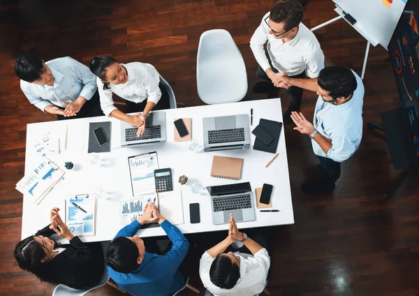 Üst düzey ofis çalışanları stratejik iş pazarlama toplantısı üzerine anlaşma yaptıktan sonra el sıkışıyor. Takım çalışması ve olumlu tutum verimli ve destekleyici bir iş yeri yaratır. Tedbirli