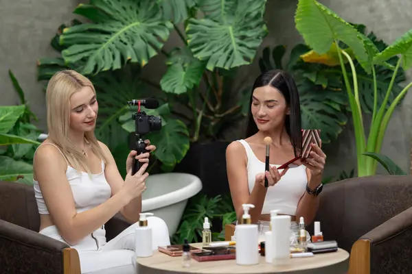緑の植物園のビデオで自然な美しさと化粧品チュートリアルを作る2つの美しいコンテンツクリエイター Selfieスティックを使用してソーシャルメディアオーディエンスに美容ケアをする方法を示す美容ブロガー ブリテット — ストック写真