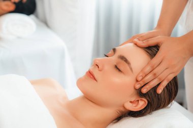 Kafkasyalı çift stres önleyici kafa masajının keyfini çıkarıyor ve lüks otellerde ya da otel spa salonlarında gündüz kaplıcalarında yüz güzelliği eğlencelerini şımartıyor. Sessiz.