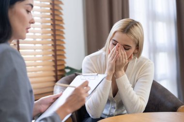 Savunmasız, stresli, genç bir hasta, ofisteki zihinsel tedavi sırasında duygusal travma, endişe ve akıl hastalıklarını psikiyatriste aktarıyor. Psikolojik danışma seansı. Blithe