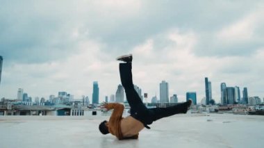 B-boy dans gösterisi çatıda sokak dansçısı ve gökyüzü dövüşçüsü, şehir manzaralı. Çekici Asyalı hipster enerjik adımlar atıyor. Break dansçı sokak dansı. Açık hava sporu 2024 hiphop..