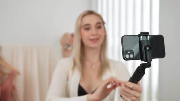 年轻的社交媒体内容创建者女人用自拍棒制作时尚视频 在制作有说服力的在线服装的同时 博客对着相机微笑 向观众或追随者推销Vlog — 图库视频影像