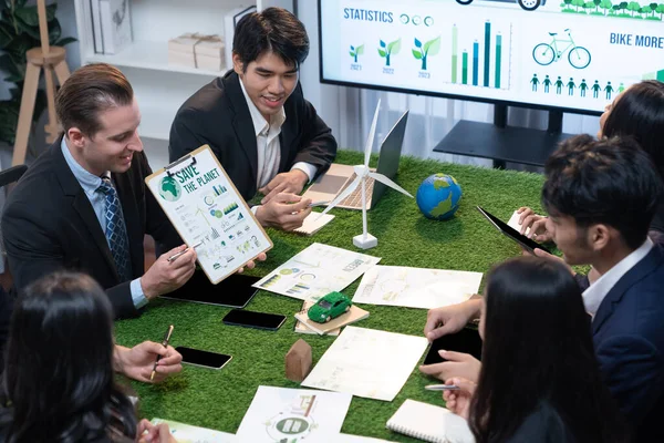 Diverse group of business people planning business marketing investment with eco-friendly policy for greener ecology. Productive teamwork contribute natural preservation and sustainable future. Quaint