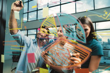 İş arkadaşı plan yaparken cam duvarı işaret eden yetenekli bir proje yöneticisi. Çeşitli iş adamları birlikte çalışıyor, pazarlama fikri ya da iş planı üzerinde kafa yoruyorlar. Yaratıcı bir başlangıç. İzleme.