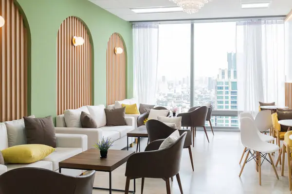 Empty stylish and modern office interior with skyscrapers view decorated with table, chair, botany decoration, elegant accessory. Living room. Modern interior. Creative design. Day light. Ornamented.