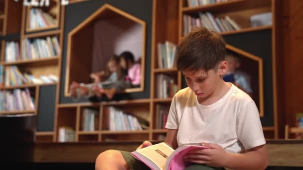 Băiatul Caucazian Uită Cameră Timp Grup Studenți Inteligenți Stând Bibliotecă — Videoclip de stoc
