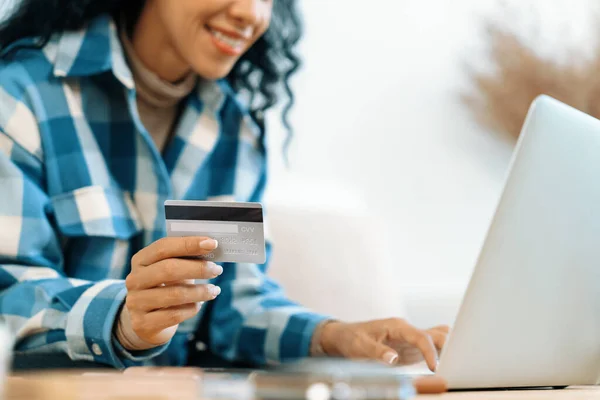 Close up credit card using for online payment, banking and shopping on the internet network with laptop computer showing credit card technology for online secured wallet top up and crucial purchase