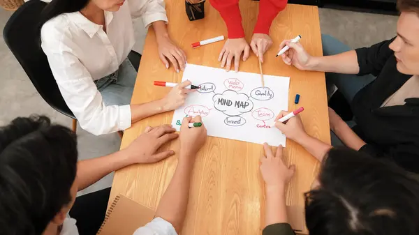Top view of professional business people hand brainstorming, working together, discussing about marketing idea by using mind map and colorful marker at meeting table. Focus on hand. Immaculate.