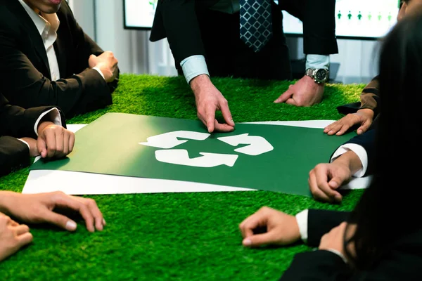 Recycle icon on meeting table in office with business people planning eco business investment on waste management as recycle reduce reuse concept for clean ecosystem. Quaint