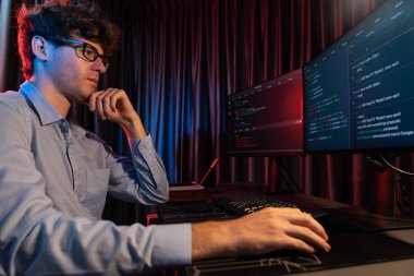 Çevrimiçi yazılım geliştirme bilgisi kodlamasını düşünen bilişim geliştiricisi yan görünümde, neon modern ofisteki web sitesinde en son sürüm uygulaması için tasarlanmış yeni bir program üzerinde çalışıyor. Toplayıcı.