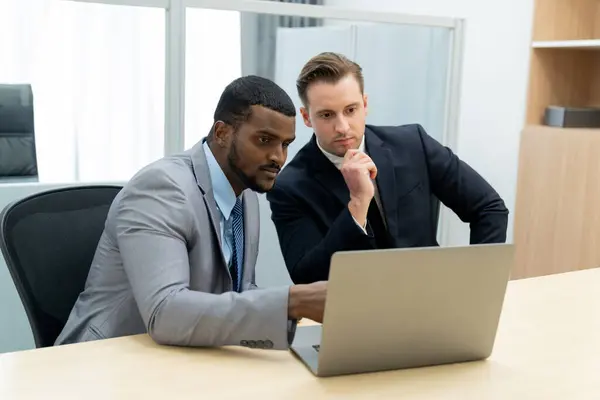Cooperative handsome african businessman present start up project while manager listen and decide to invest. Two businesspeople making agreement, reporting data. Multicultural business. Ornamented.