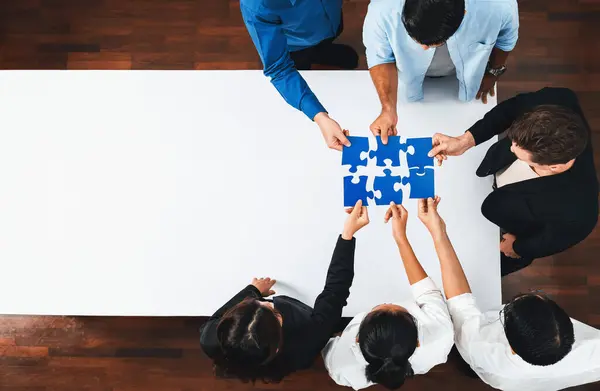 Top view panorama banner of business team joining jigsaw puzzle together over meeting table symbolize business partnership and collective unity teamwork in problem solving solution. Prudent