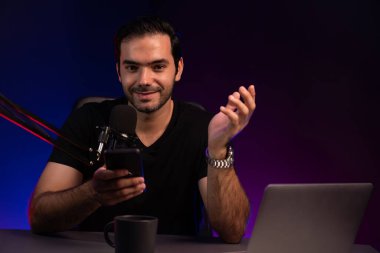 Canlı yayında dinleyiciyle konuşan yayıncı, Mor Neon Işık Stüdyosu 'ndaki yaratıcı pozitif düşünce konseptiyle sosyal medyada akıllı telefondan mesajları kontrol ediyor. Tahmin et..