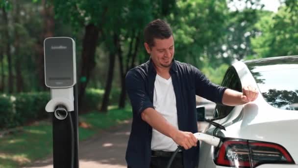 Mann Lädt Batterie Für Elektroauto Während Der Fahrt Elektroauto Naturwald — Stockvideo