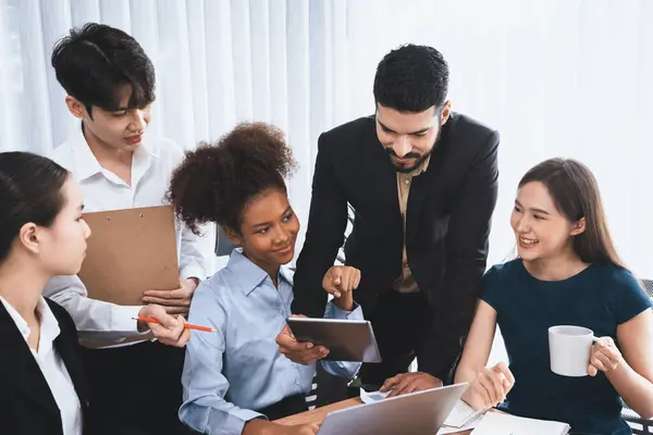 stock image Happy diverse business people work together, discussing in corporate office. Professional and diversity teamwork discuss business plan on desk with laptop. Modern multicultural office worker. Concord