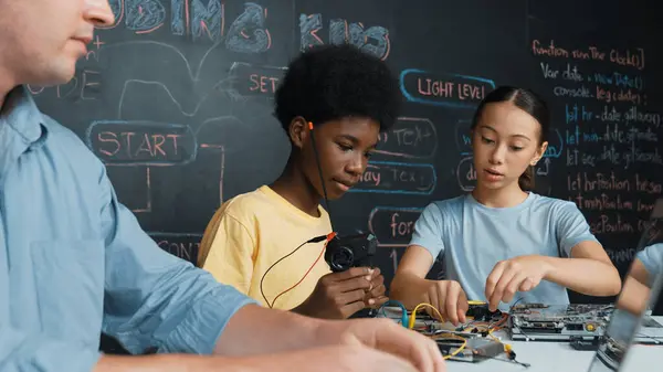 Young Student Fixing Controller While Teacher Programing Engineering Code Stem — Stock Photo, Image