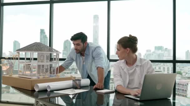 Smart Architect Engineer Inspect House Model While Colleague Using Laptop — Stock Video