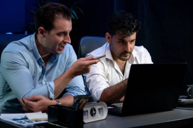 İşadamı ortaklar, geceleri dizüstü bilgisayarla yeni mağazanın tanıtımında ürün piyasaya sürme pazar payını tartışıyor. Beyin fırtınası ekibi pazarlama stratejisini analiz etmeye çalışıyor. Satılabilir.